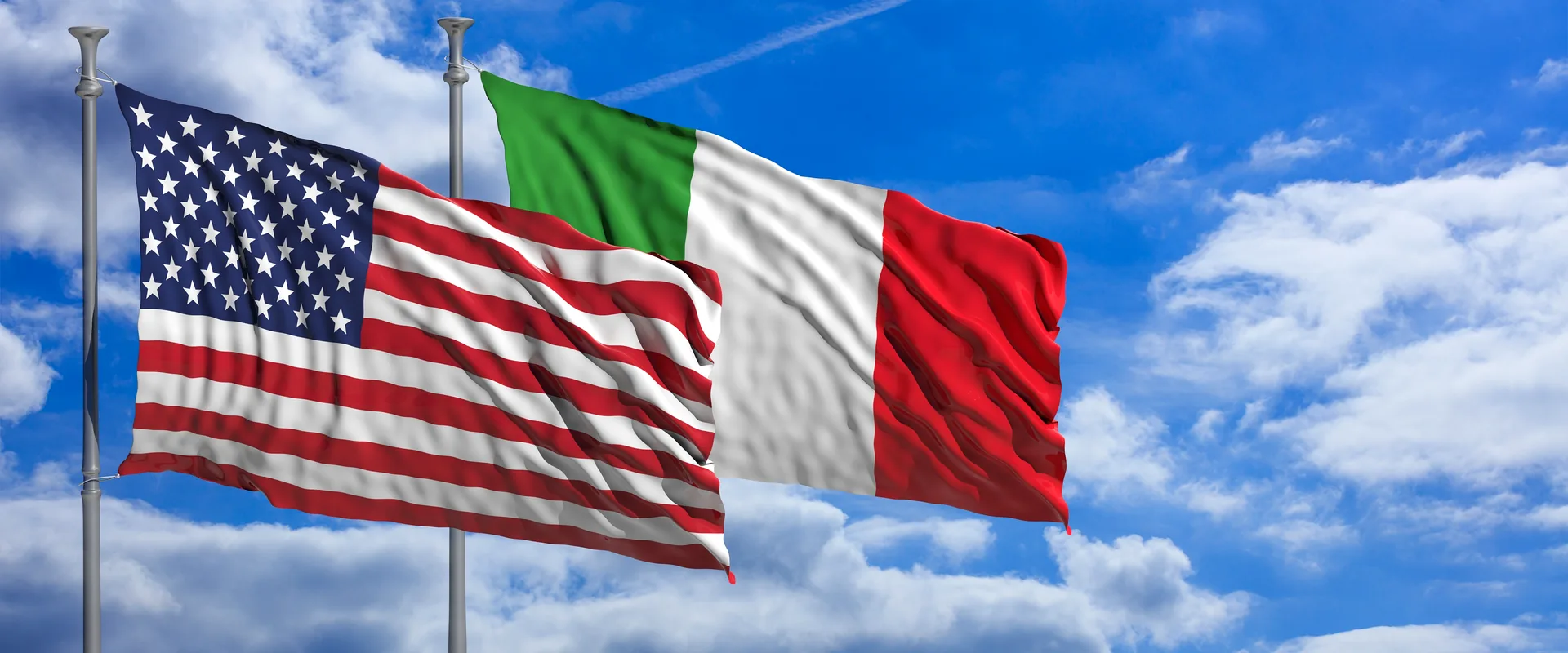 US and Italian flags flying together against a blue sky symbolising the EB-5 investor visa route from Italy to the United States
