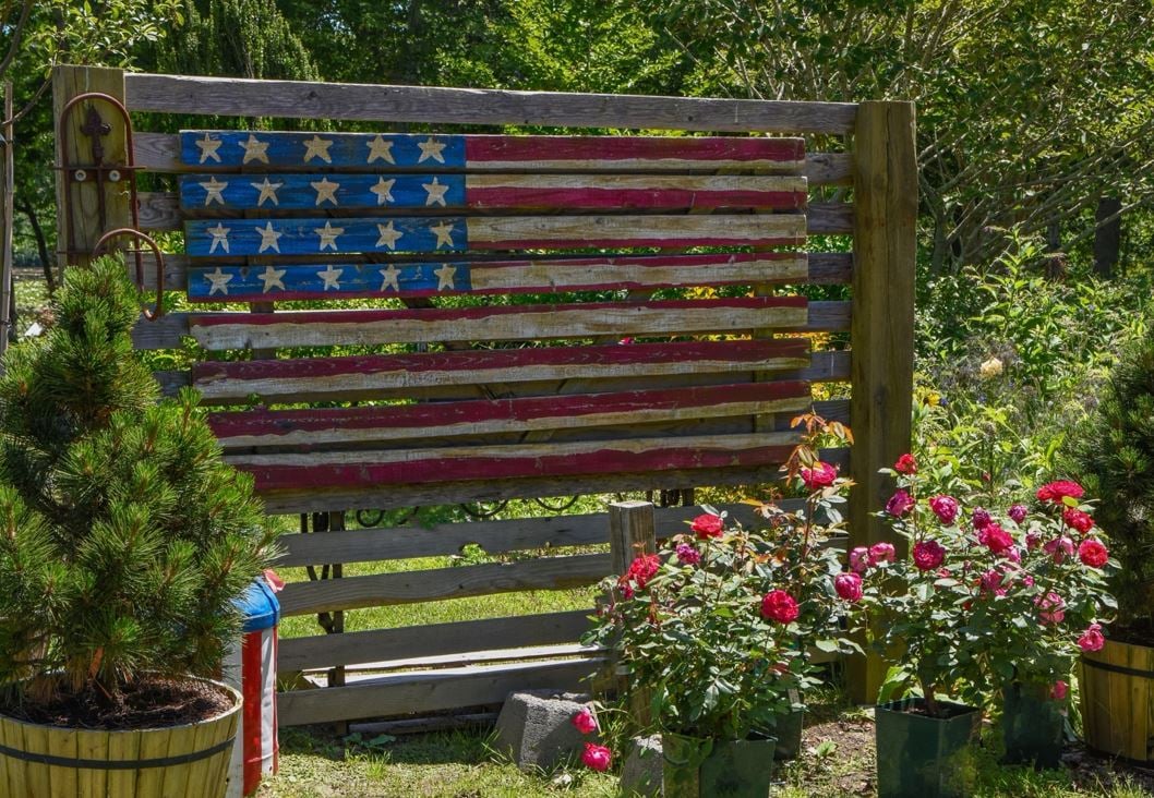 Rustic wooden American flag displayed in a garden, symbolizing U.S. immigration opportunities for residents of Dubai.