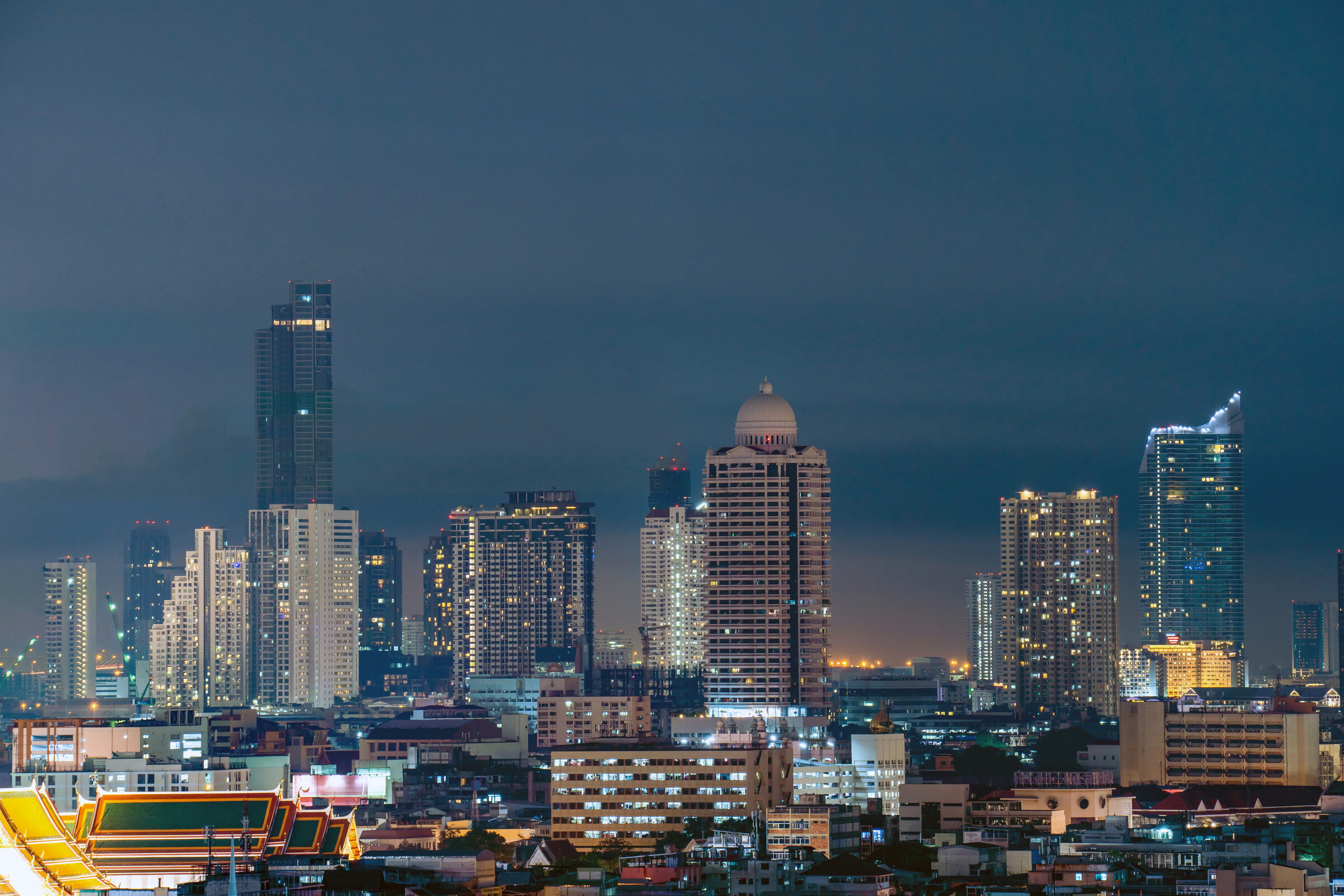 Sathorn financial district skyline, Bangkok, at night: E-2 visa lawyers for Thai investors
