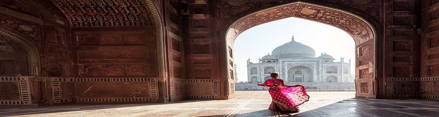 Indian professional in traditional dress near the Taj Mahal considering what is an L1 visa for the USA from India