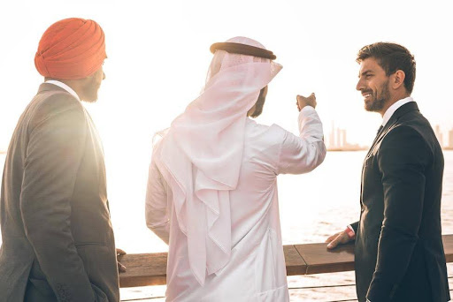 Pakistani business owners in Dubai discussing EB-5 investment strategy with immigration lawyers for U.S. green card through UAE-based wealth